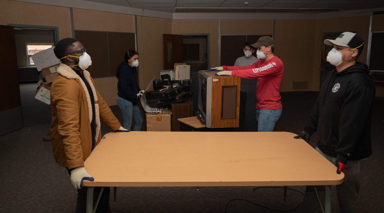 people moving table in room